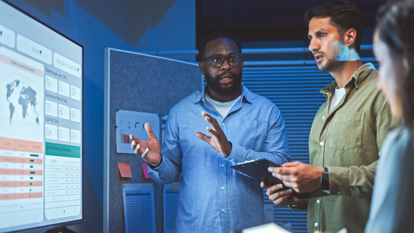 A Leader Collaborates With Other Colleagues Near a Presentation