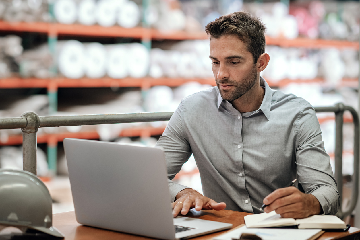 Supply Chain Manager Working on a Laptop at a Desk