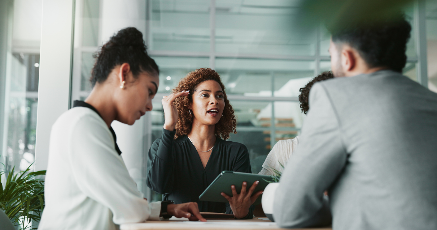 An Accountant With a Tablet Talks to Colleagues