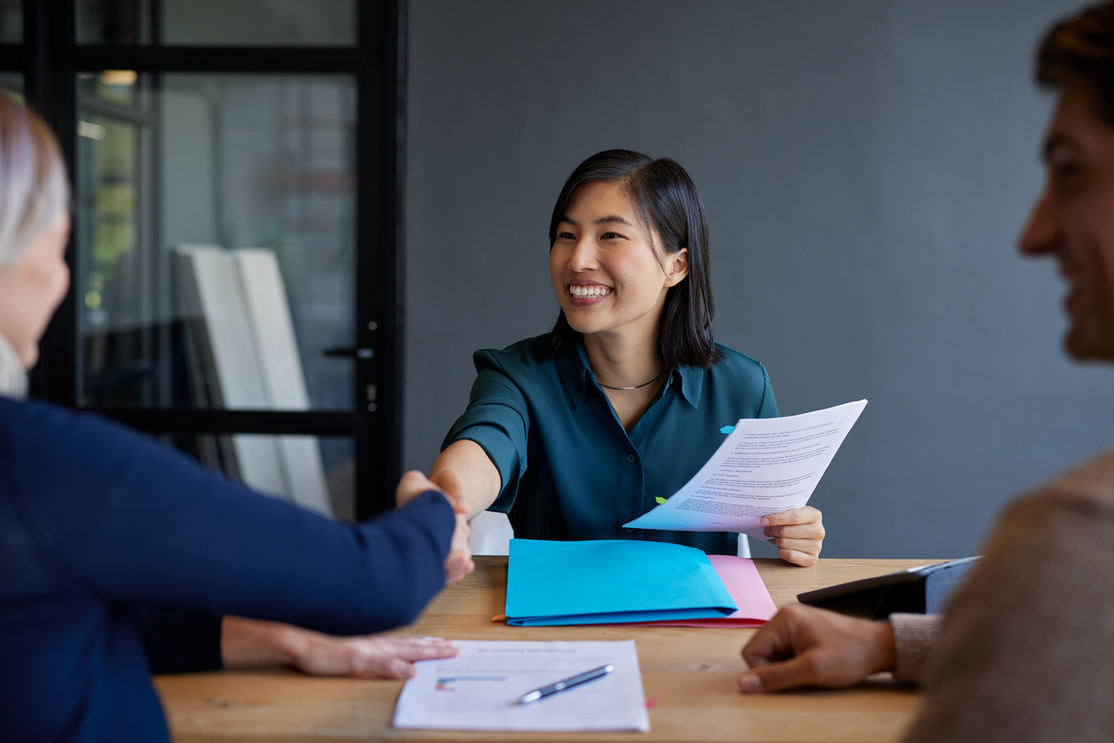 A Budget Analyst Meets With Colleagues in a Conference Room