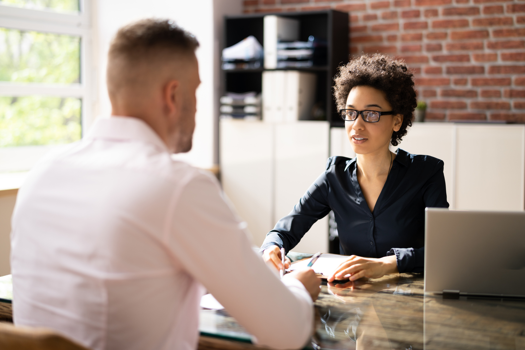 A probation officer meets with a client in their office.