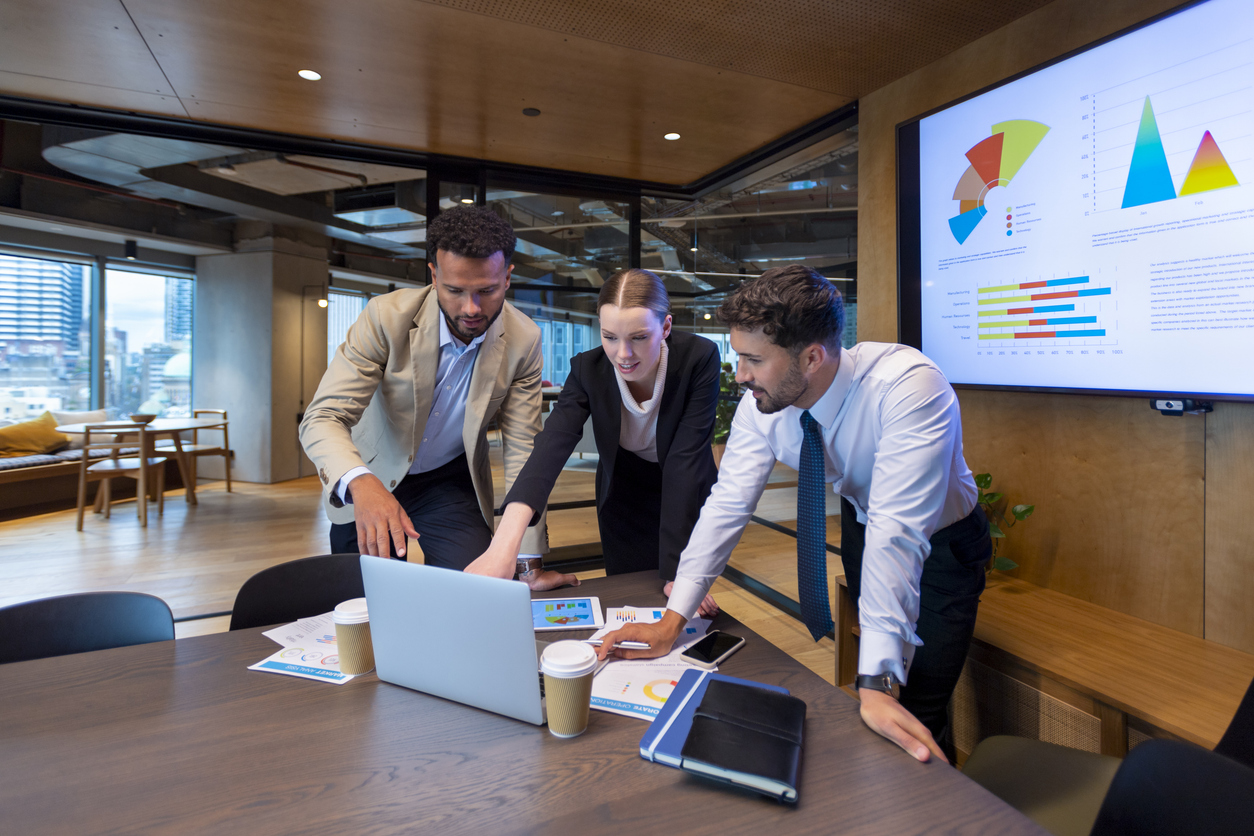 Three Accountants Collaborate at a Conference Table..jpg