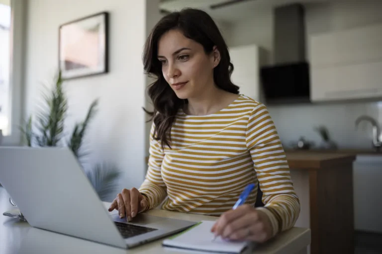 A person works on a laptop in an office.